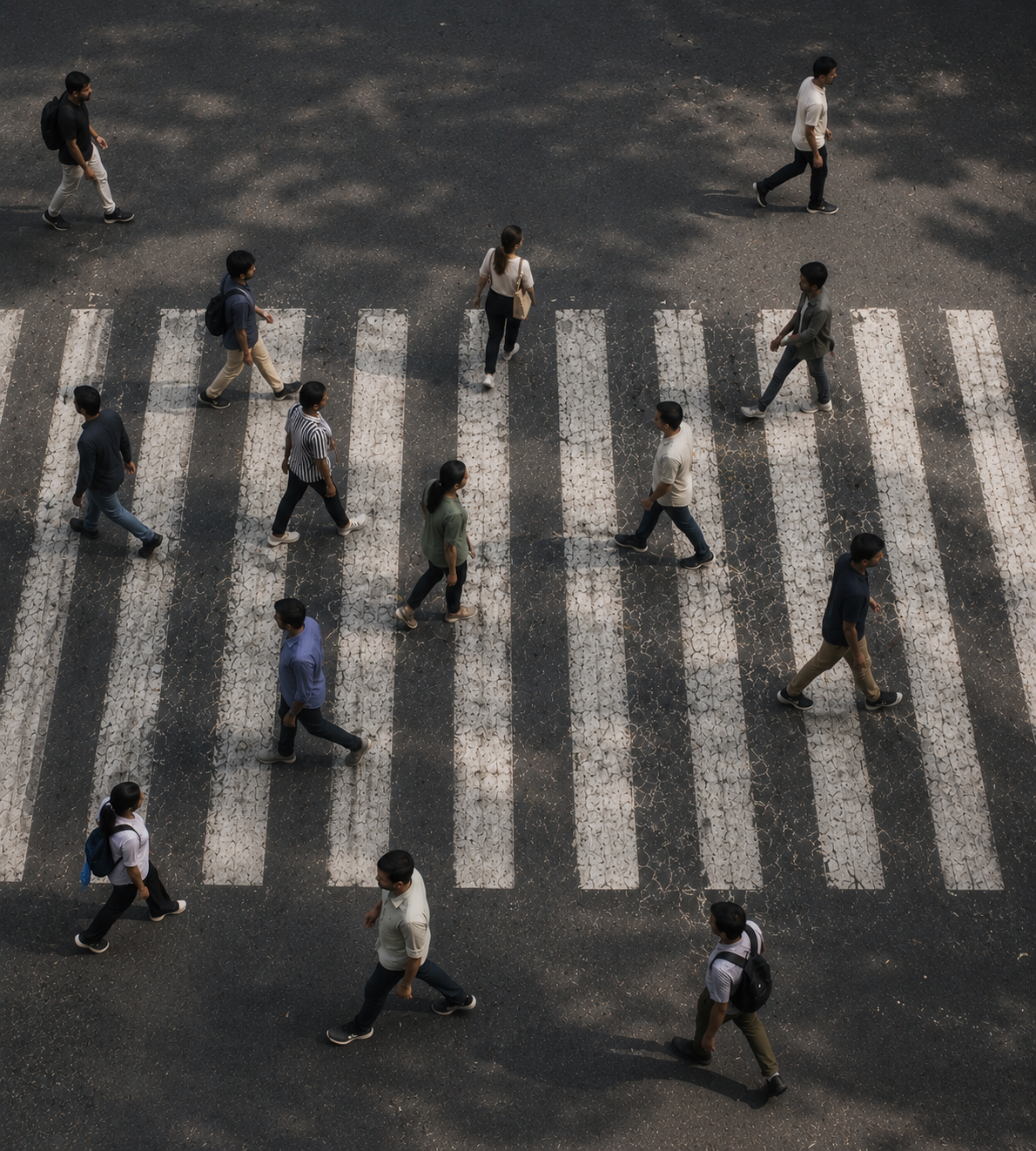 Pedestrians crossing a city street on a zebra crossing.